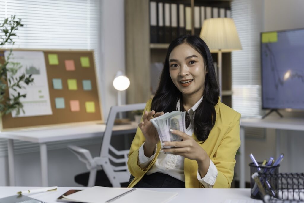 A young business woman surprised at the value the highest paying jobs offer beyond a paycheck.